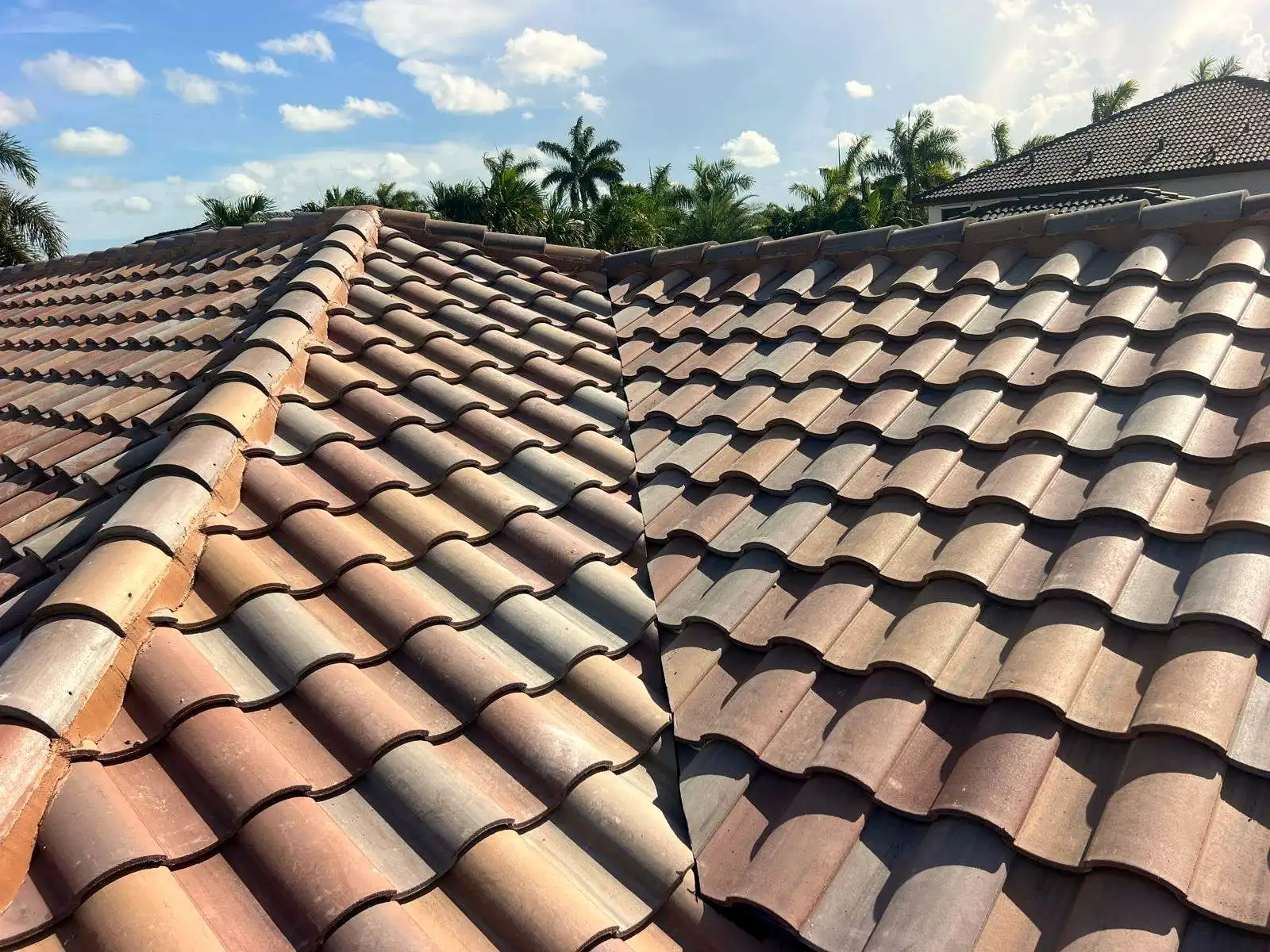 Clay barrel tile roof meeting at a valley