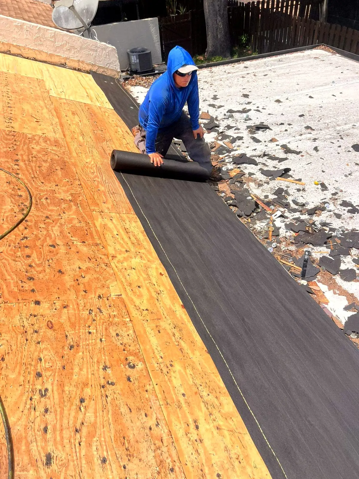 New plywood roof decking with the first course of underlayment being rolled over it