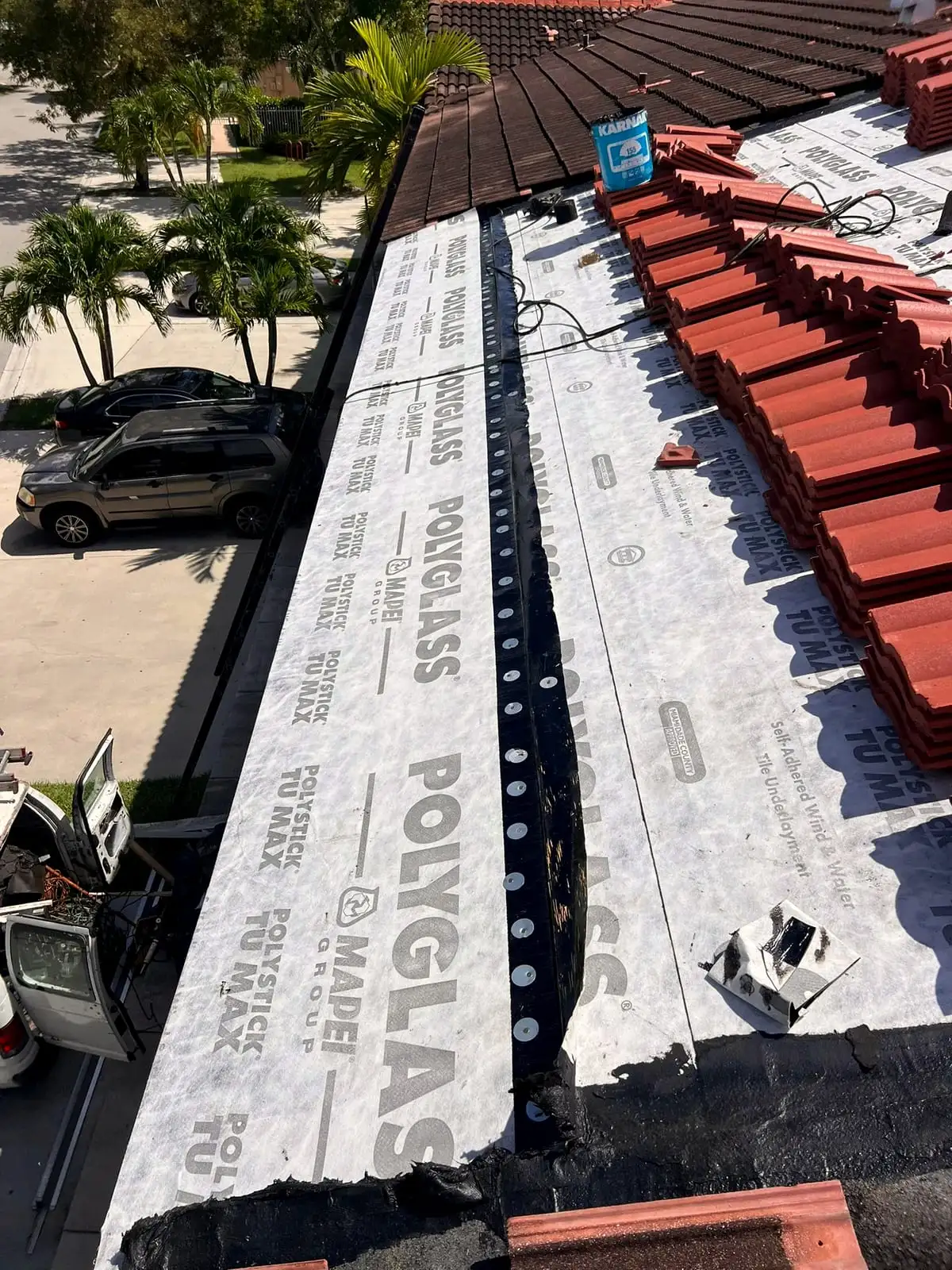 Roof tile stacked on new self-adhered underlayment, ready to be laid